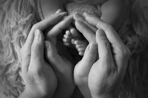baby feet with parents hands